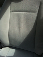 Burn holes in seat back